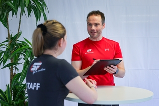 Der Trainer führt mit der Auszubildenden die mündliche Prüfung durch.